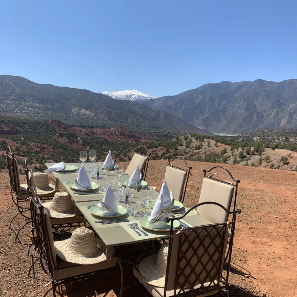 An outdoor dining table set for a meal in the Moroccan mountains